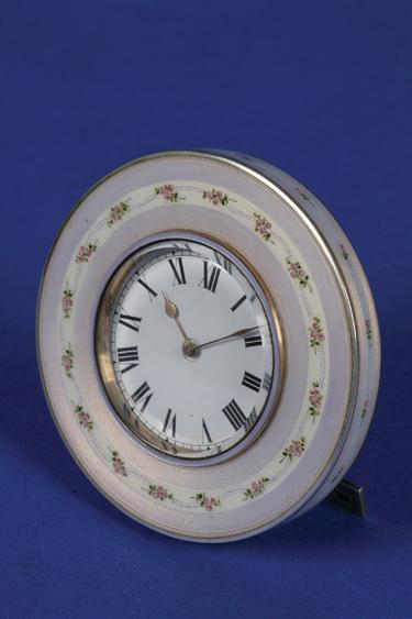 Appraisal: A GERMAN SILVER AND ENAMEL DRESSING TABLE CLOCK of circular