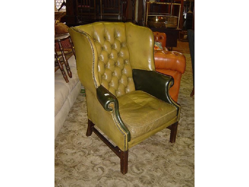 Appraisal: A Georgian style wing armchair with green leather upholstered seat