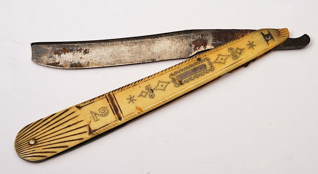 Appraisal: AN CT BONE HANDLED SCRIMSHAW CUT THROAT RAZOR with inlaid