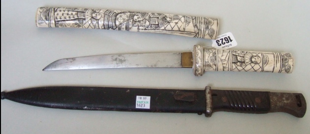 Appraisal: A Japanese bone tanto with slightly curved steel blade cm