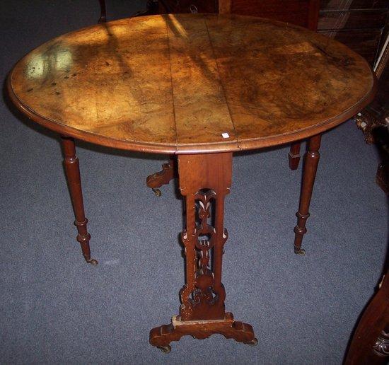 Appraisal: A mid Victorian burr walnut oval two-flap table on pierced