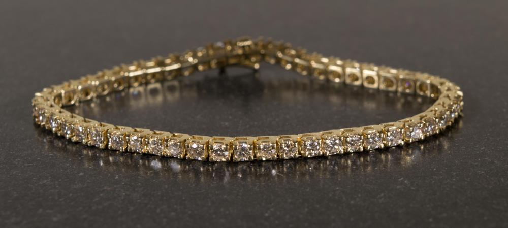 Appraisal: DIAMOND AND FOURTEEN KARAT GOLD TENNIS BRACELET The yellow gold