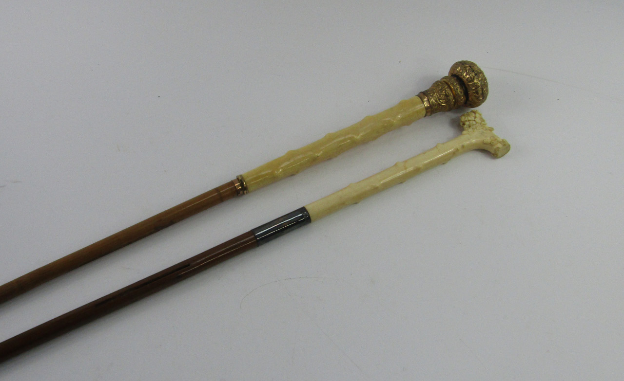 Appraisal: Two Victorian ivory parasol handles one carved with flowers silver