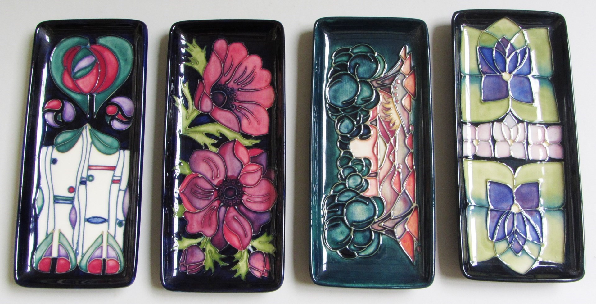 Appraisal: Four Moorcroft rectangular dishes late th century each tube line