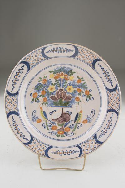 Appraisal: Delft Charger ca with central polychrome floral urn and parrots