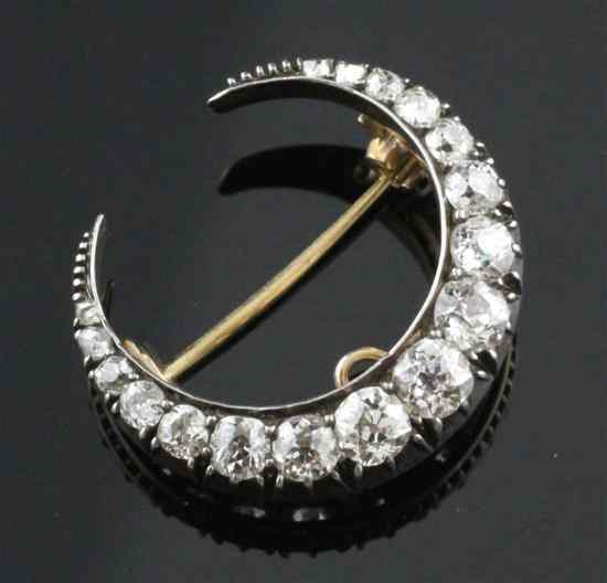 Appraisal: An Edwardian gold and diamond crescent pendant brooch set with