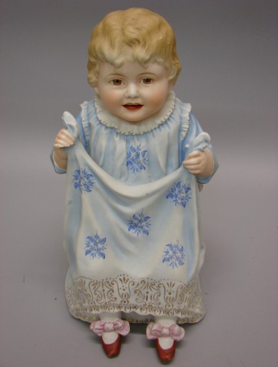 Appraisal: Figurine of child holding her skirt Smiling child is sitting