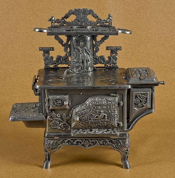 Appraisal: Cast iron and nickel Floral toy stove '' Cast iron