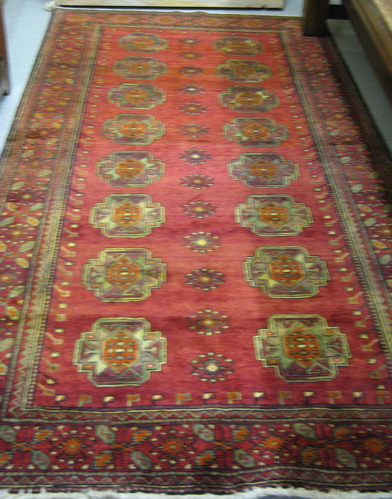 Appraisal: PERSIAN TURKOMAN BELOUCH CARPET having two columns of geometric Turkoman