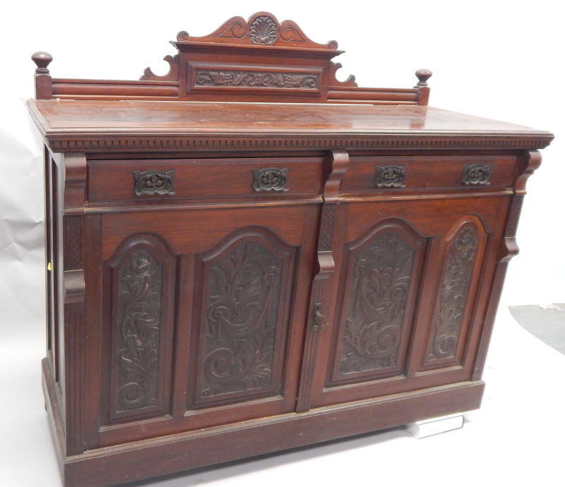 Appraisal: A late Victorian walnut sideboard with a raised back above