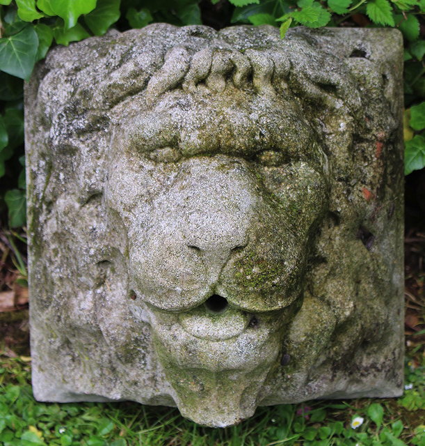 Appraisal: A WEATHERED CAST STONE LIONS MASK WALL FOUNTAIN cm squared