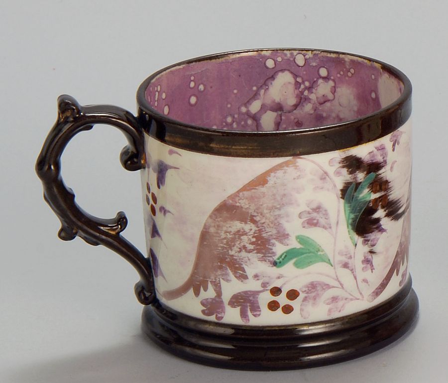 Appraisal: SUNDERLUND LUSTRE MUG English th CenturyWith foliate decoration and brown