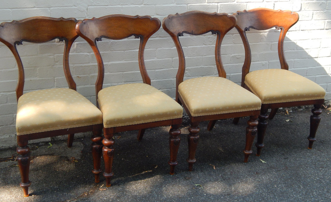 Appraisal: A set of four Victorian walnut dining chairs having elaborate