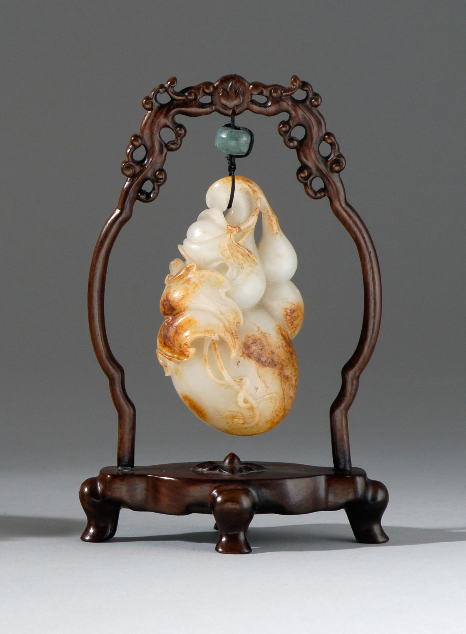 Appraisal: CELADON AND RUSSET JADE PENDANT th CenturyIn the form of