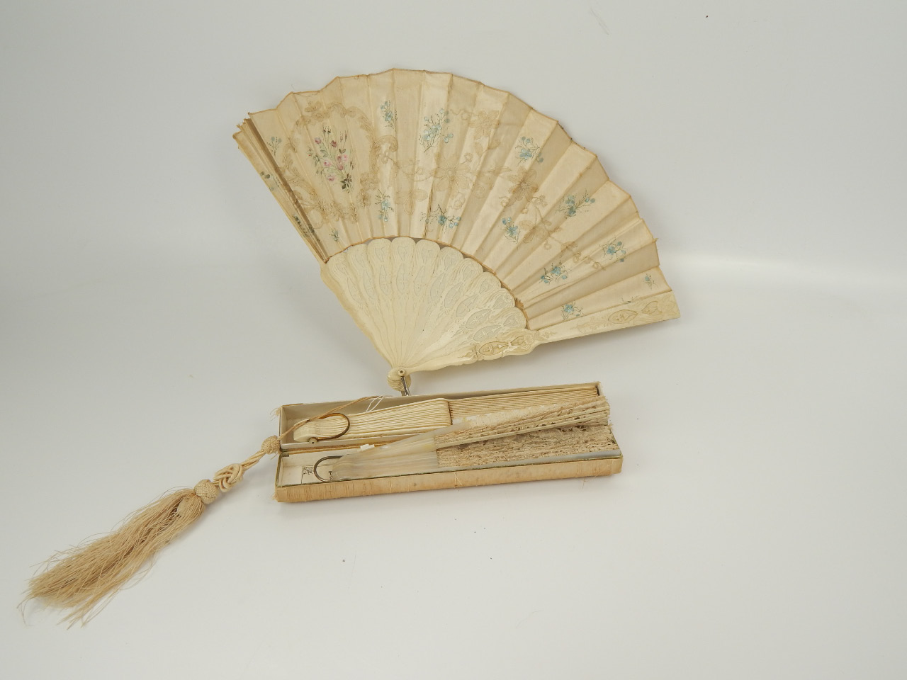 Appraisal: A Victorian bone and satin silk fan with hand worked