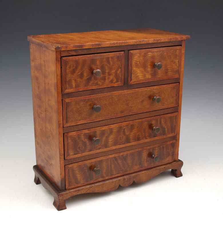 Appraisal: MINIATURE BURLED CHIPPENDALE CHEST half drawers over full drawers ''