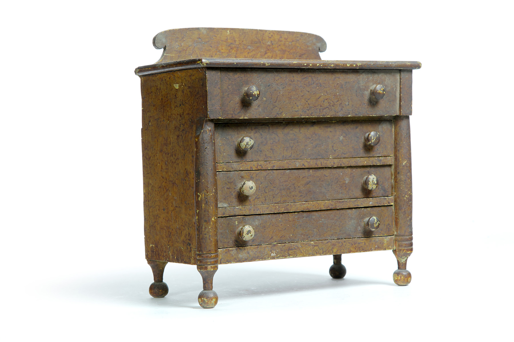 Appraisal: AMERICAN DECORATED MINIATURE CHEST OF DRAWERS Nineteenth century pine Scrolled