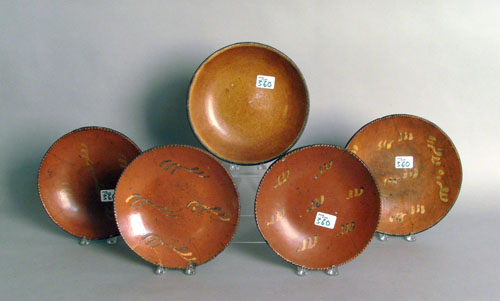 Appraisal: Five redware plates four with yellow slip decoration dia -