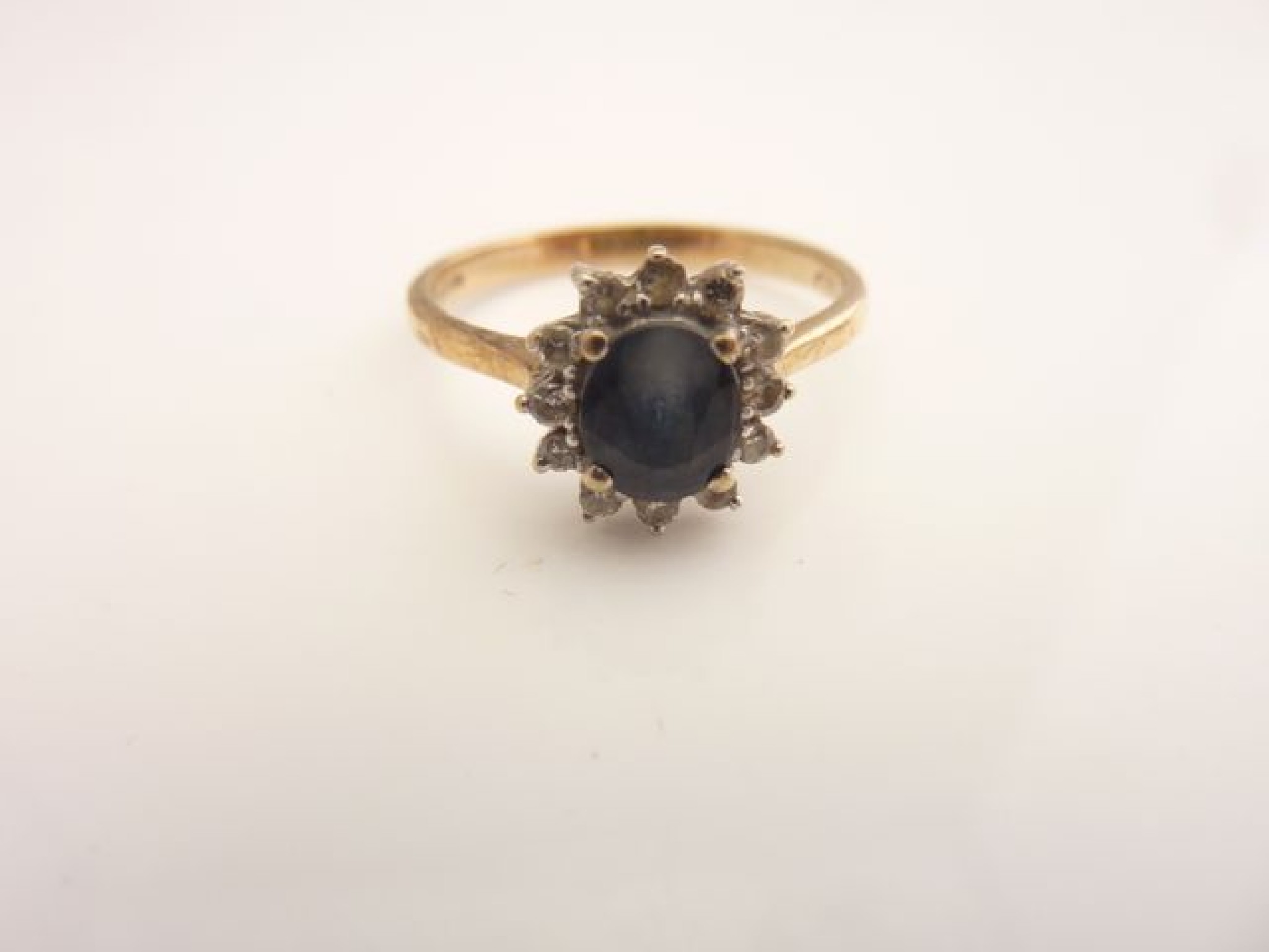 Appraisal: A sapphire and diamond ring centred with an oval mixed-cut