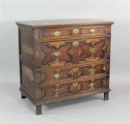 Appraisal: An early th century oak chest of four geometric drawers