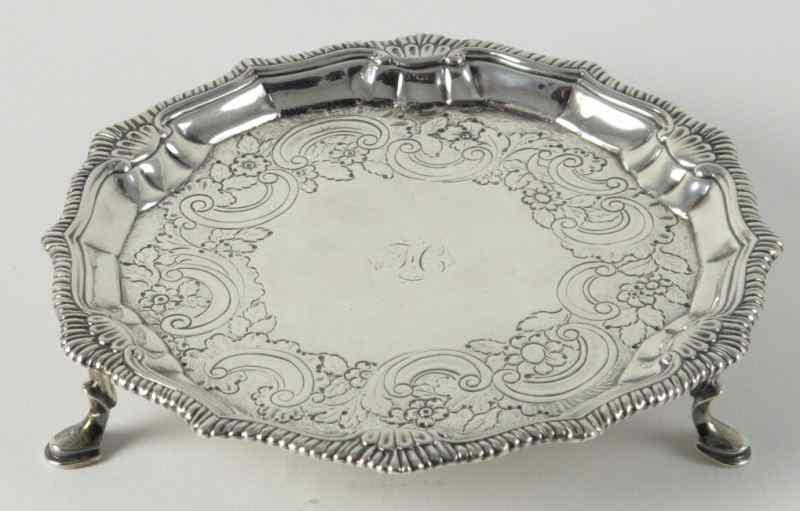 Appraisal: Irish Sterling Silver Salverheavily engraved shaped border resting on three