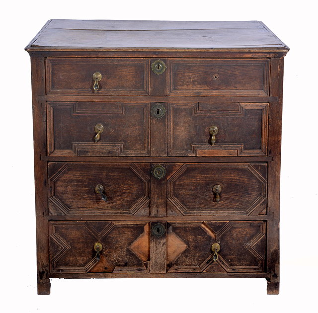 Appraisal: A CHARLES II OAK CHEST of four drawers with applied