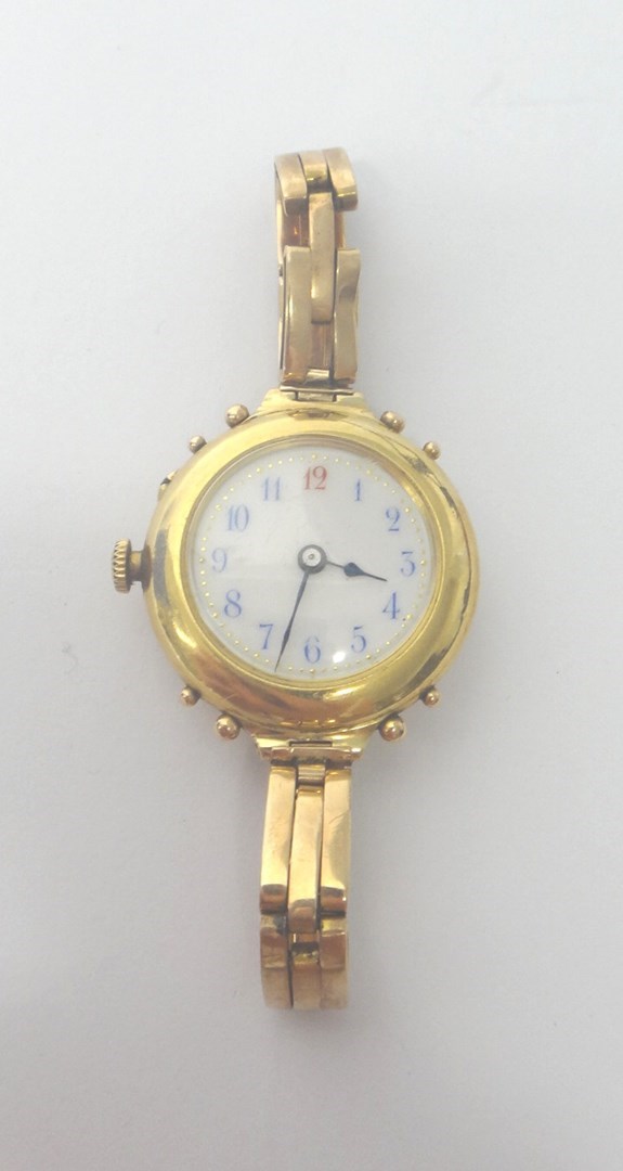 Appraisal: A lady's gold circular cased wristwatch with a gilt jeweled