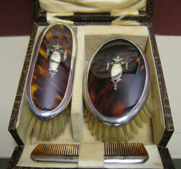 Appraisal: TORTOISESHELL BABY DRESSER SET Three-piece two brushes and a comb