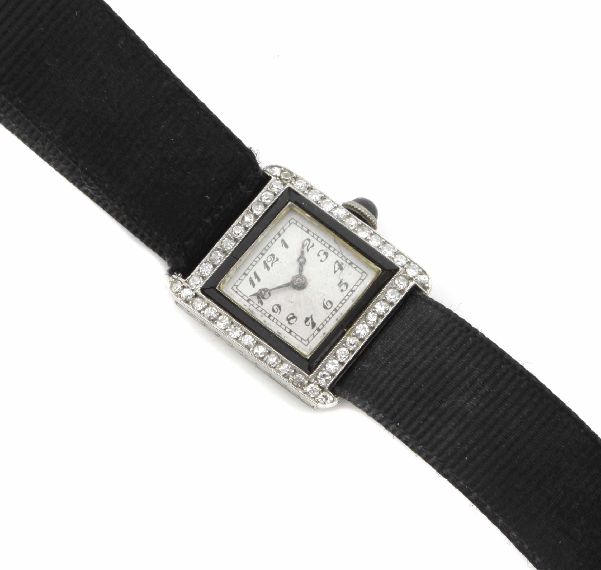 Appraisal: A lady's diamond onyx and platinum wristwatch attached to a