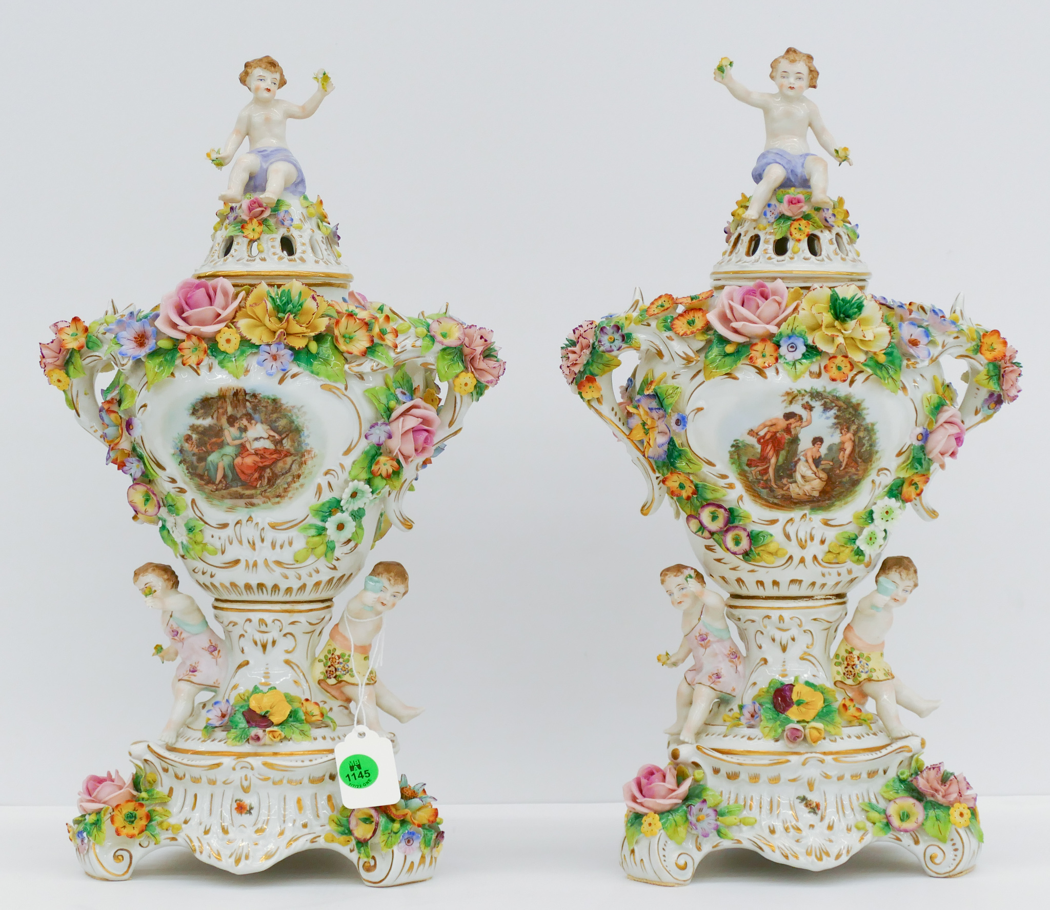 Appraisal: Pair Sitzendorf Floral Porcelain Putti Urns '' - Some scattered