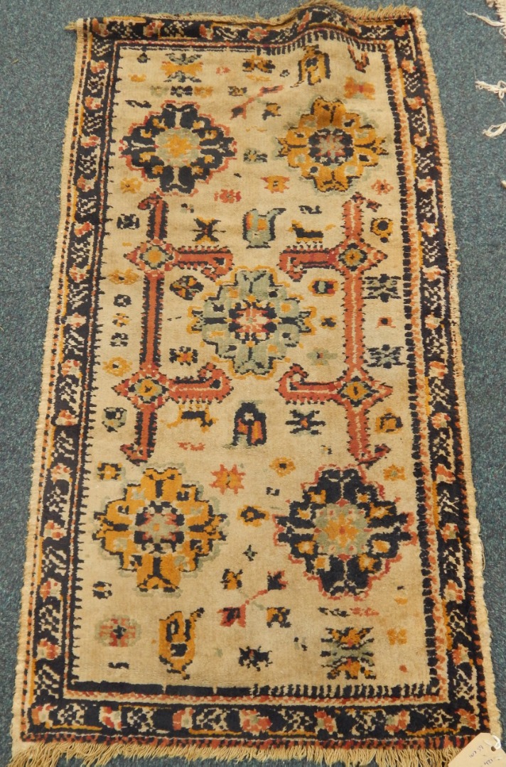 Appraisal: A Caucasian prayer rug decorated with geometric motifs and symbols