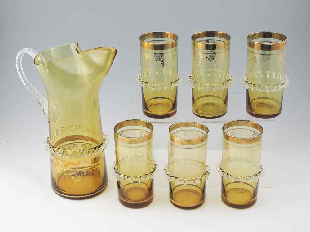 Appraisal: VENETIAN GLASS PITCHER AND TUMBLERS Rigaree and gilt decorated amber