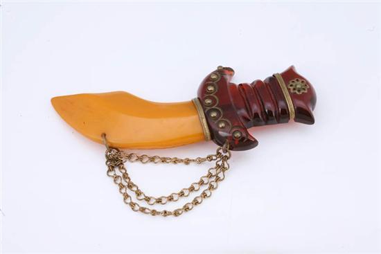 Appraisal: BAKELITE SWORD PIN Rootbeer carved hilt and varigated butterscotch blade