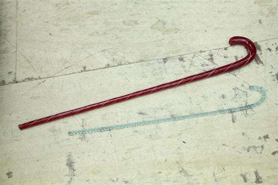 Appraisal: TWO GLASS CANES Deep red with white ropetwist decoration ''