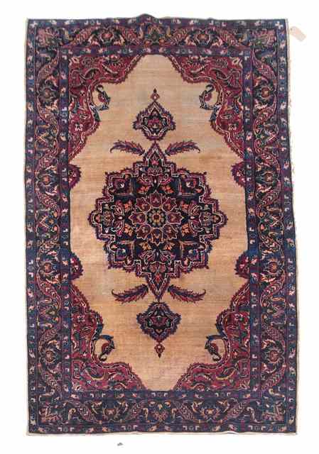 Appraisal: A SAROUK CAMEL GROUND RUG with a central blue ground