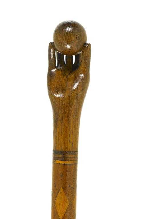 Appraisal: A CARVED AND INLAID WOOD WALKING CANE the handle in