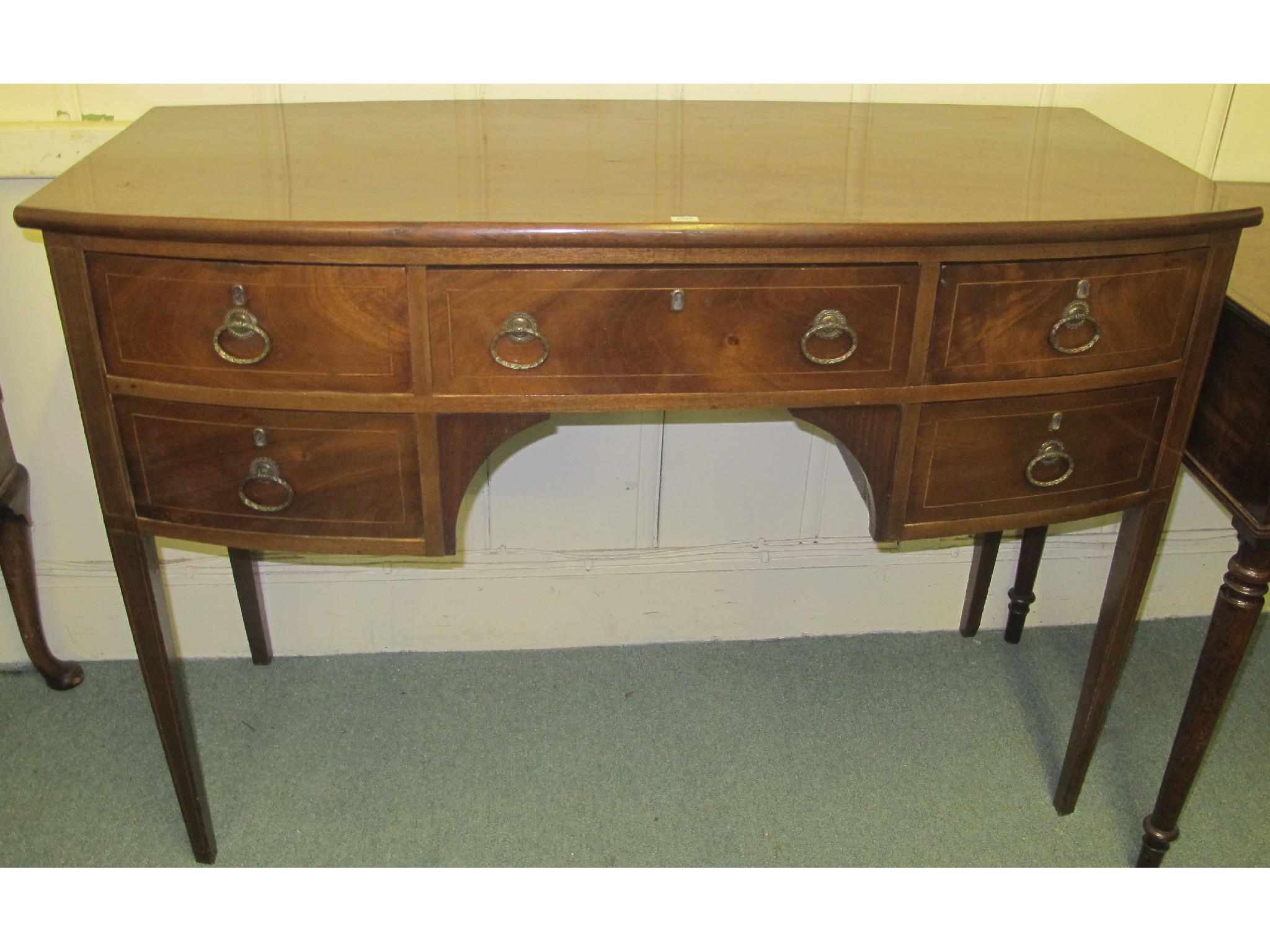 Appraisal: A mahogany bowfront sideboard