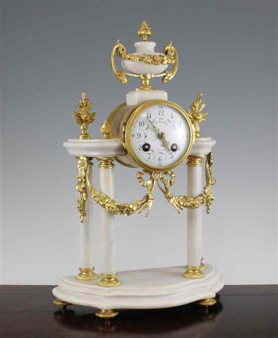 Appraisal: A French ormolu mounted white marble portico clock with floral