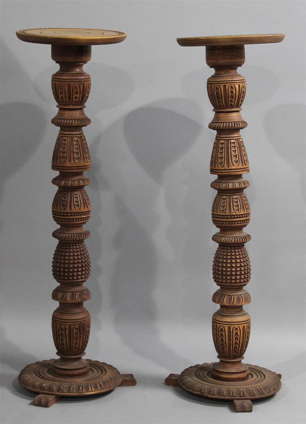 Appraisal: PAIR OF ORNATELY CARVED WOODEN PEDESTALS each having a round