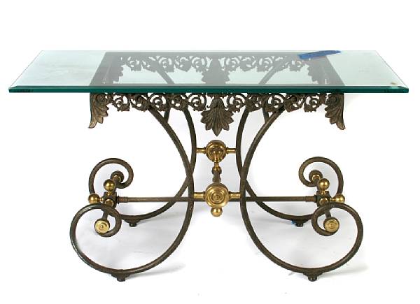 Appraisal: A cast iron and brass mounted garden table with glass