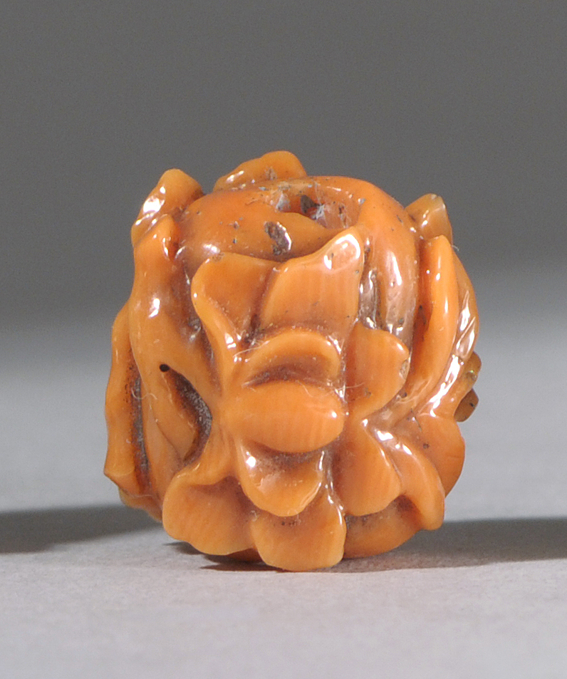 Appraisal: CARVED CORAL OJIME Meiji PeriodIn seed form with raised paulownia