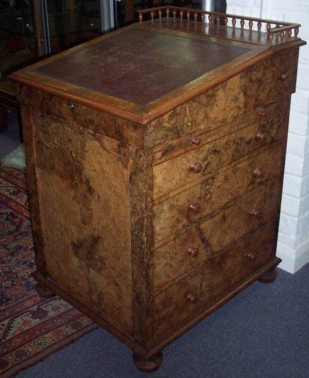 Appraisal: An early Victorian figured walnut Davenport with spindle turned gallery