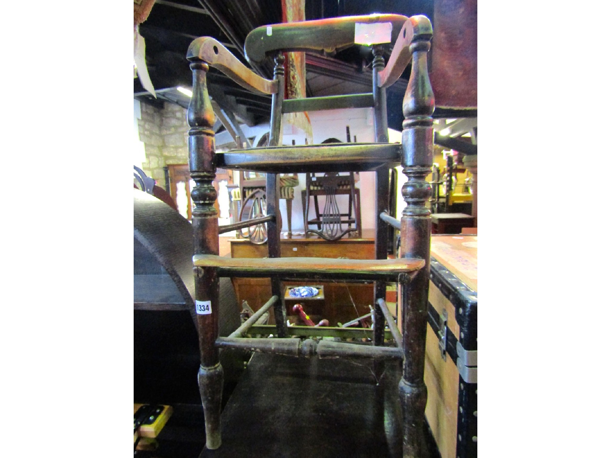 Appraisal: A Victorian child's high chair with stained beechwood frame shaped