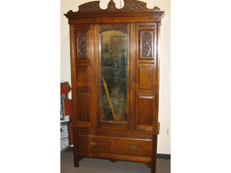 Appraisal: ENGLISH MAHOGANY WARDROBE Foliate carved crest over the central arched