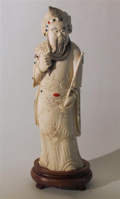 Appraisal: Chinese elephant ivory and gem mounted guardian figure th century