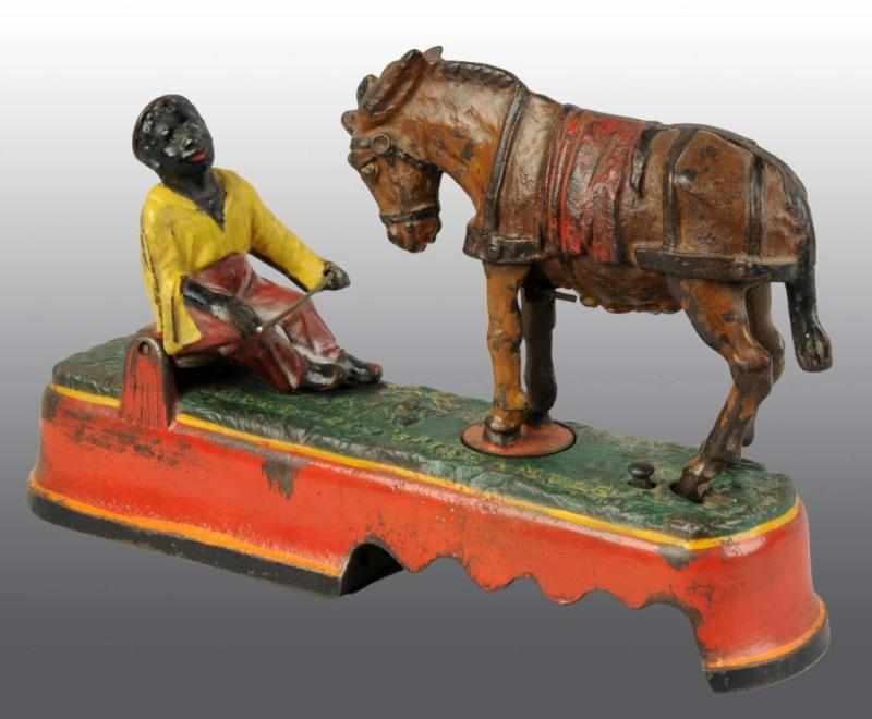 Appraisal: Cast Iron 'Spise a Mule Mechanical Bank Description Manufactured by