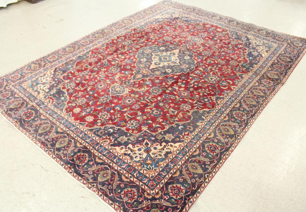 Appraisal: HAND KNOTTED PERSIAN CARPET floral and central floral medallion design