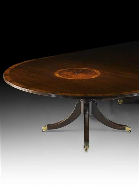 Appraisal: A mahogany and rosewood crossbanded four pillar dining table In