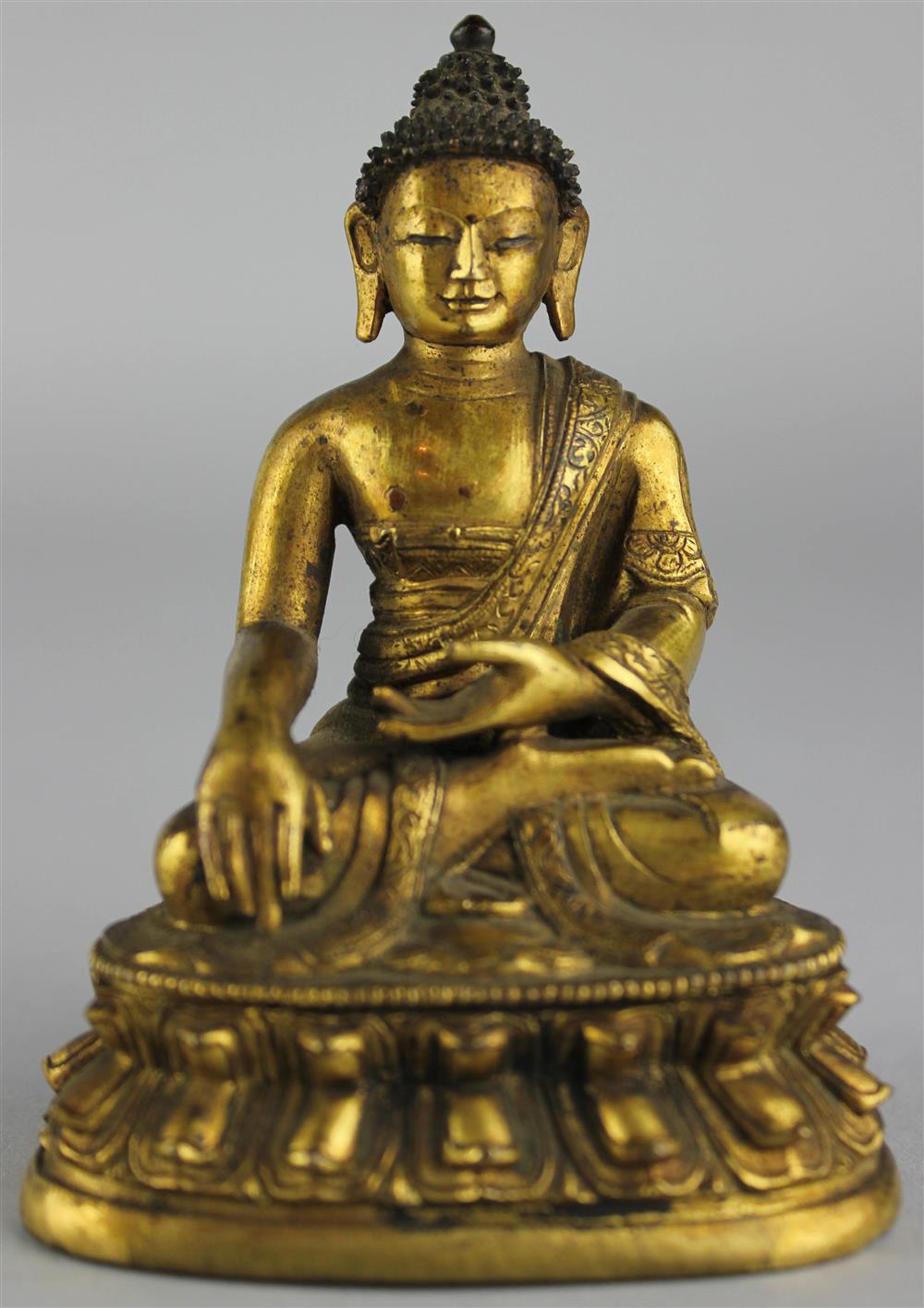 Appraisal: A SMALL SINO-TIBETAN GILT-BRONZE SEATED BUDDHA th century seated cross