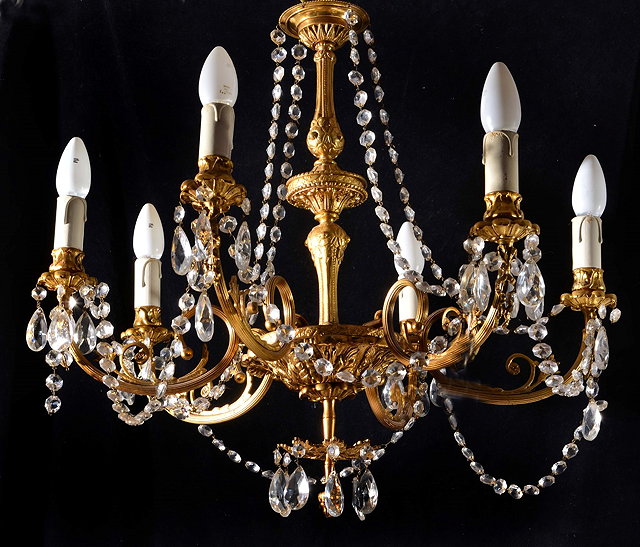 Appraisal: A GILT METAL SIX BRANCH CHANDELIER with facet cut drops